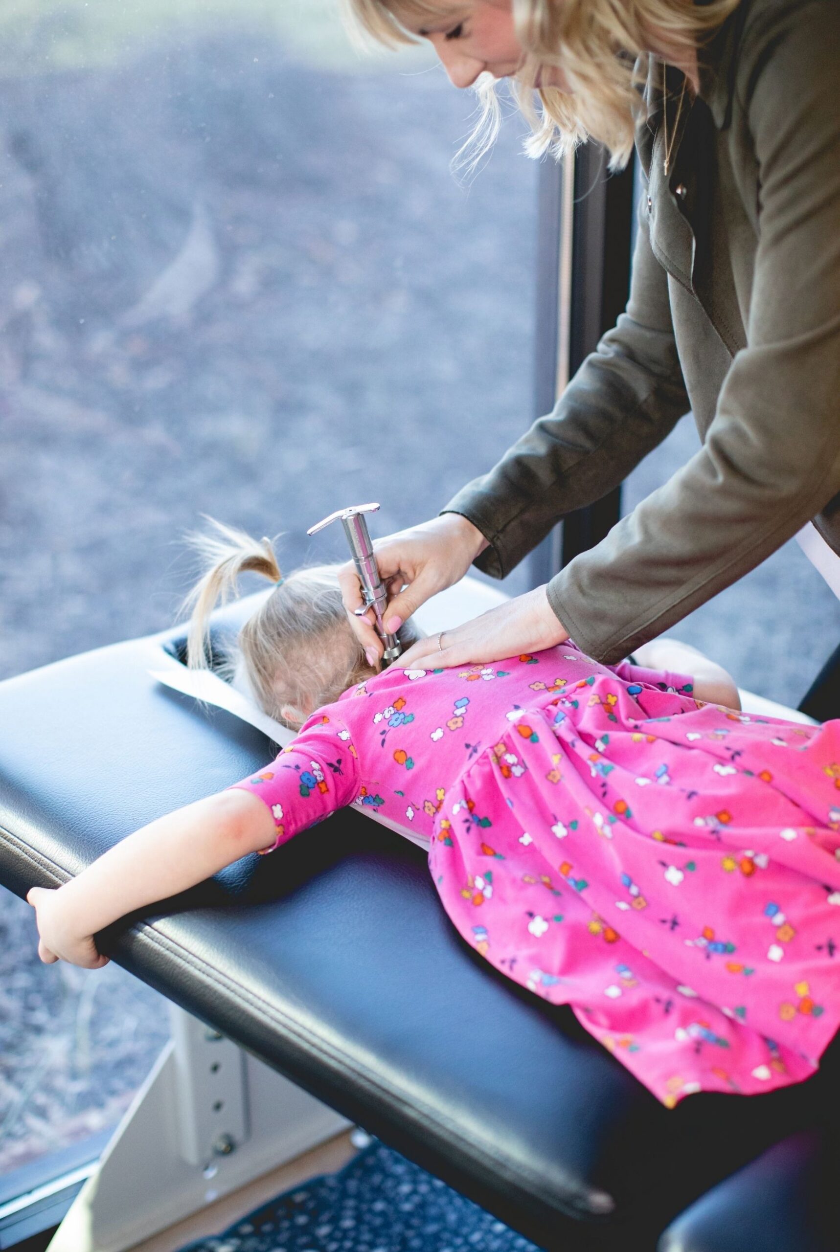 Dr. Clare Stewart performing a pediatric Torque Release Technique adjustment, Stewart Chiropractic Center, Hendersonville TN